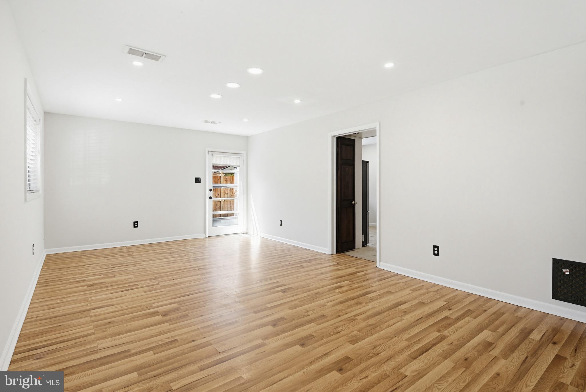 9717 Hedin Drive Silver Spring, MD 20903 - Photo 7 of 36 a view of an empty room with wooden floor