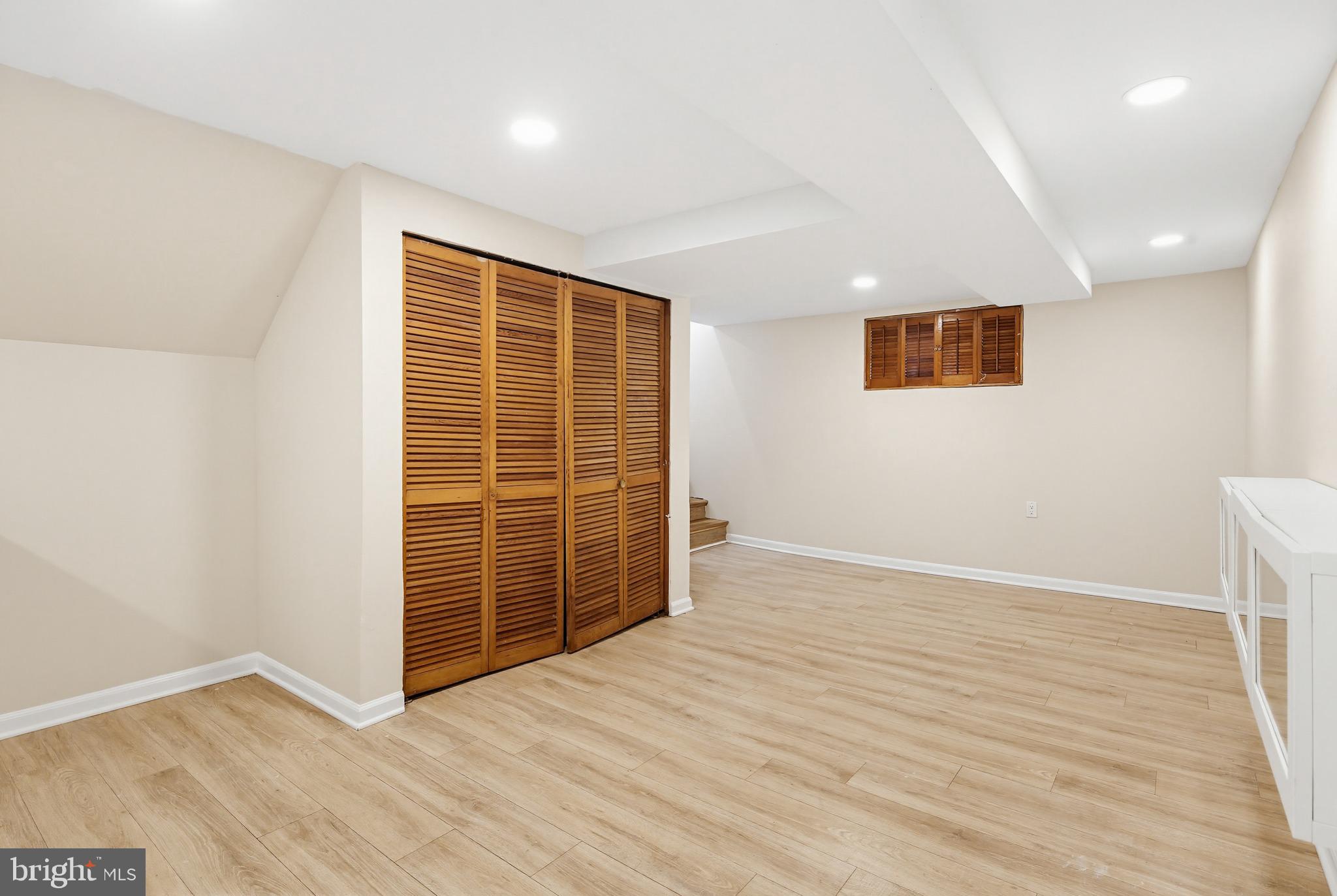 9717 Hedin Drive Silver Spring, MD 20903 - Photo 10 of 36 an empty room with wooden floor and windows