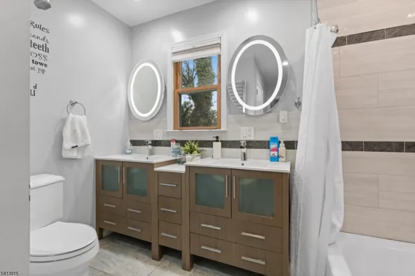 a bathroom with a toilet a sink and a mirror