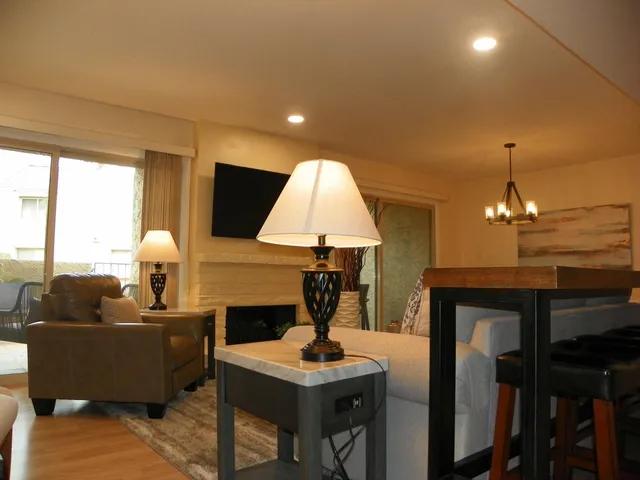 a living room with furniture a lamp and a chandelier
