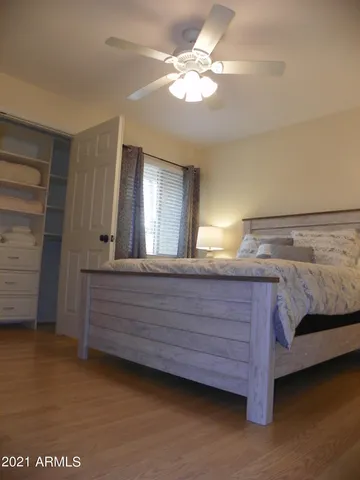 a bedroom with a bed and a chandelier