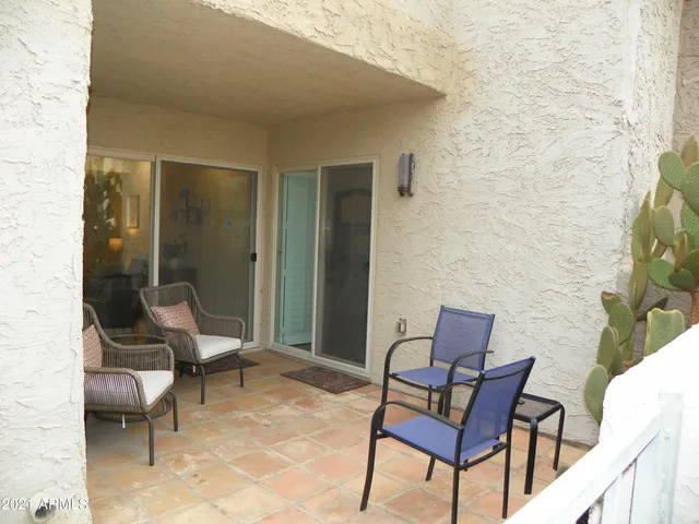a outdoor living space with furniture and a rug