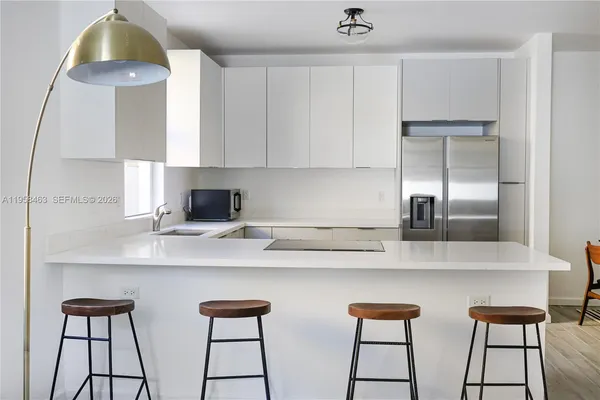 a kitchen with stainless steel appliances a sink and cabinets