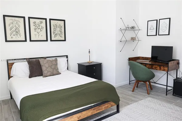 a bedroom with a bed a desk and chair