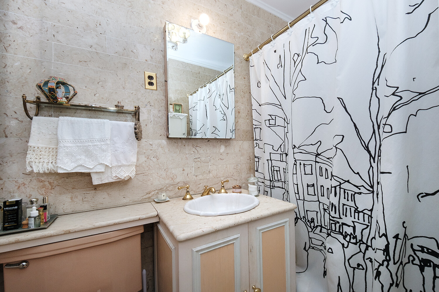 25 East 69th Street, Unit 5B Manhattan, NY 10021 - Photo 12 of 22 a bathroom with a sink and mirror with toilet