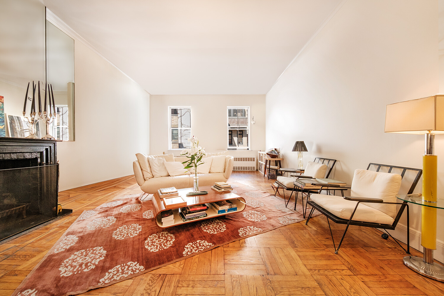 25 East 69th Street, Unit 5B Manhattan, NY 10021 - Photo 3 of 22 a living room with furniture wooden floor and a fireplace