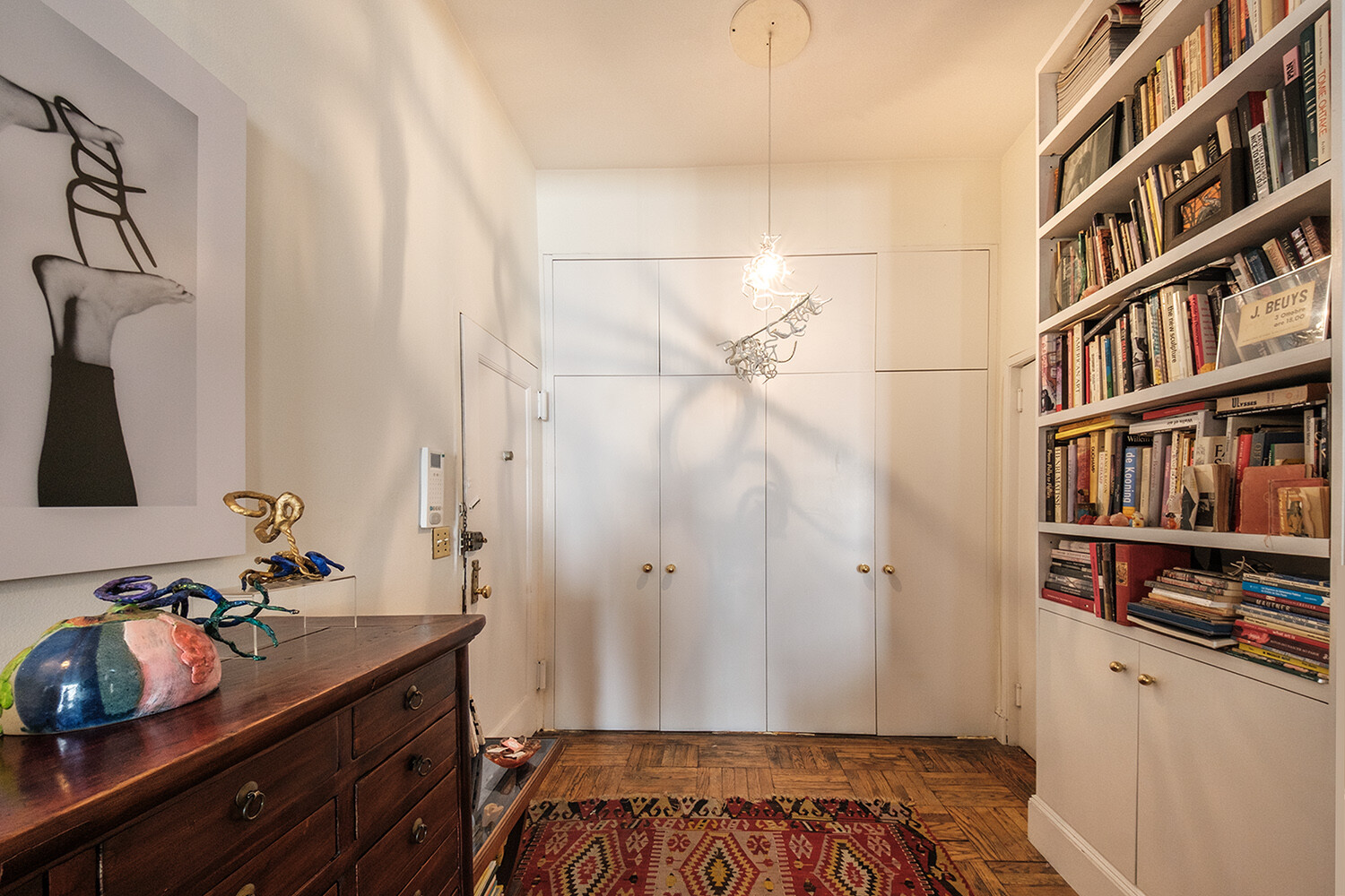 25 East 69th Street, Unit 5B Manhattan, NY 10021 - Photo 8 of 22 a bedroom with a bed and a book shelf