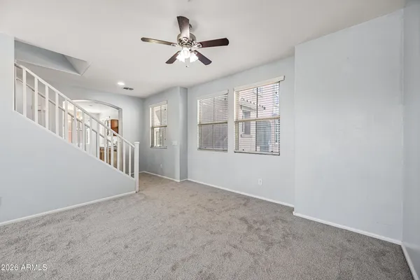 a view of a livingroom with a ceiling fan and window