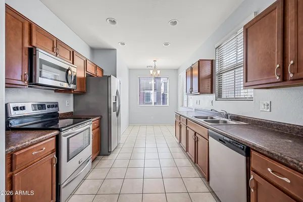 an empty room with windows and ceiling fan
