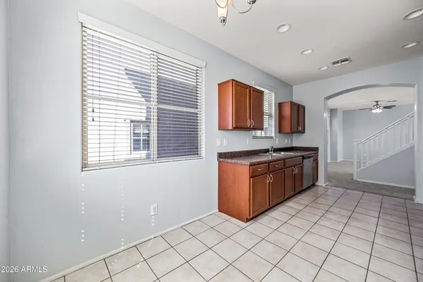 a kitchen with granite countertop a refrigerator stove and microwave