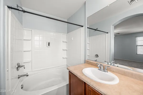 a living room with a bed furniture and a window