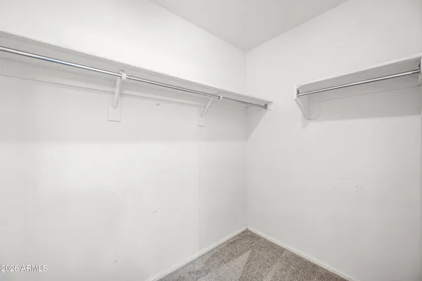 an empty room with closet and windows