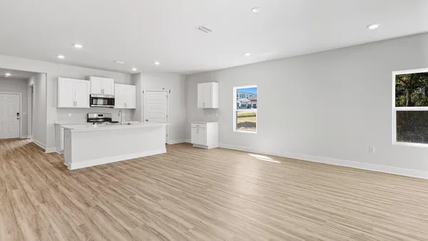 a view of kitchen with granite countertop cabinets and wooden floor