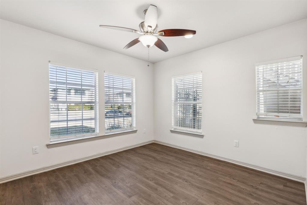4402 Swiss Avenue Dallas, TX 75204 - Photo 4 of 11 a view of an empty room with wooden floor and a window