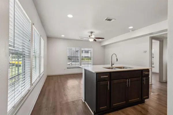 a view of kitchen with sink and wooden floor