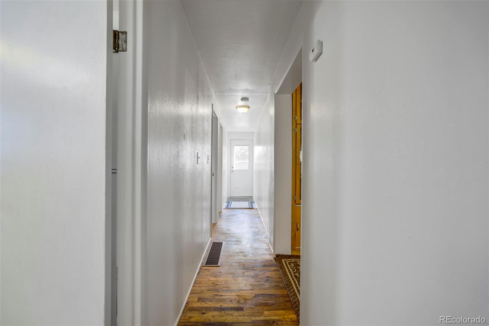 1284 Thompson Street Limon, CO 80828 - Photo 45 of 49 a view of a hallway with wooden floor