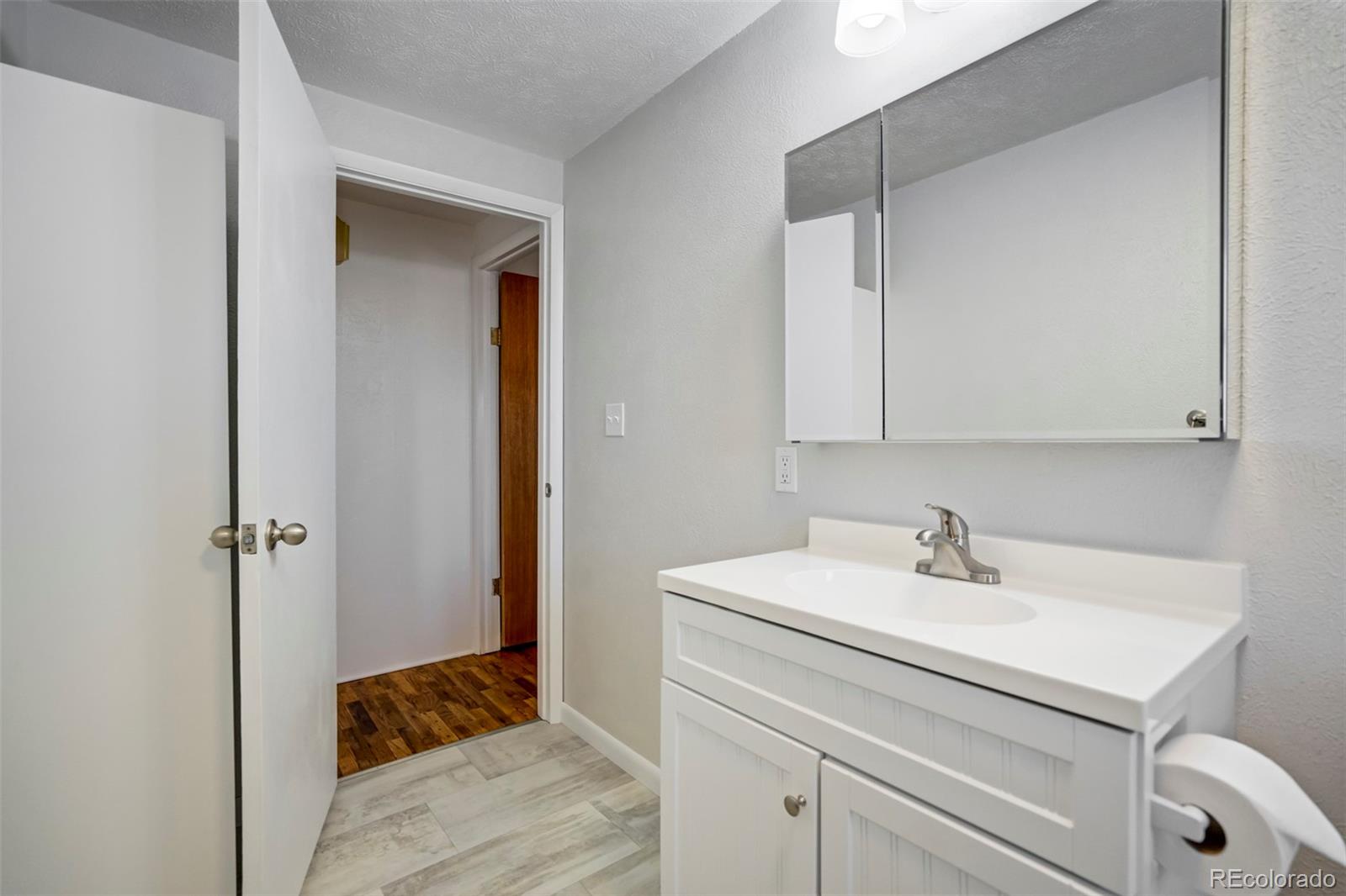 1284 Thompson Street Limon, CO 80828 - Photo 10 of 49 a bathroom with a sink and a mirror