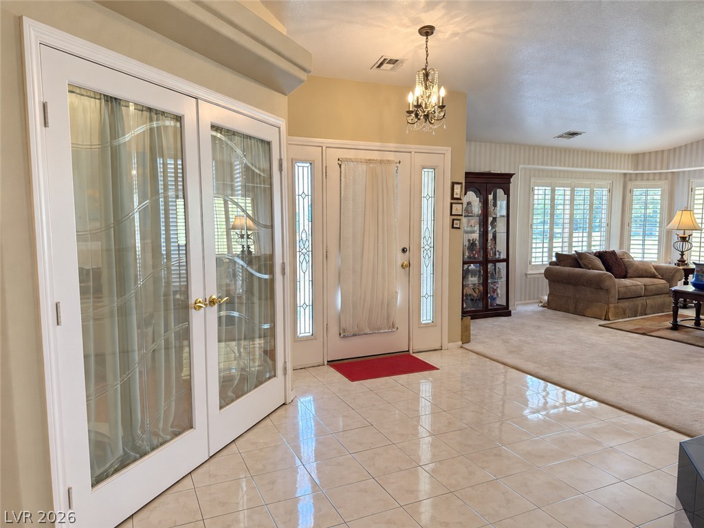 5470 Grain Mill Road Pahrump, NV 89061 - Photo 5 of 80 Gleaming tile floors welcome guests inside this airy entryway leading directly to the living room.