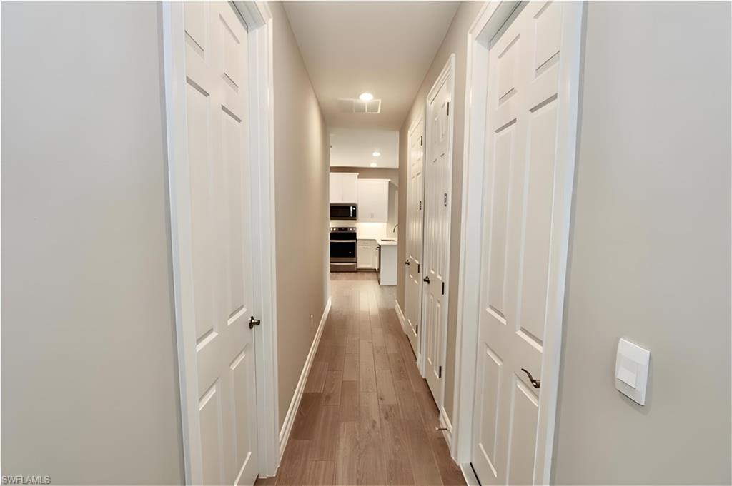 1063 Enbrook Loop Naples, FL 34114 - Photo 15 of 26 a view of a hallway with wooden floor and staircase