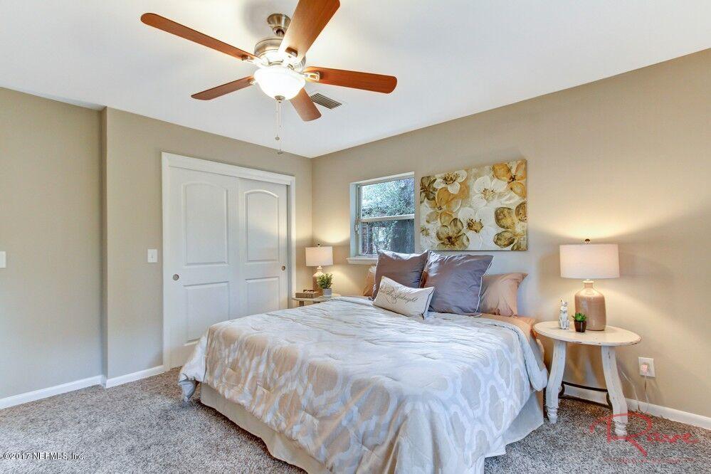 413 Baisden Road Jacksonville, FL 32218 - Photo 11 of 31 a bedroom with a bed and a table