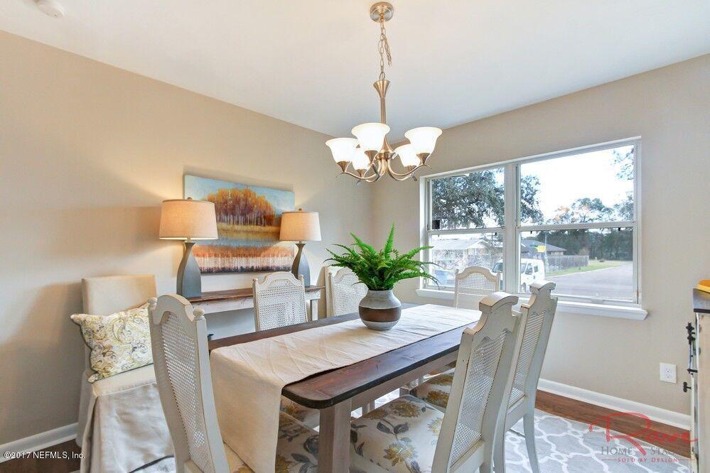 413 Baisden Road Jacksonville, FL 32218 - Photo 16 of 31 a dining room with furniture and chandelier