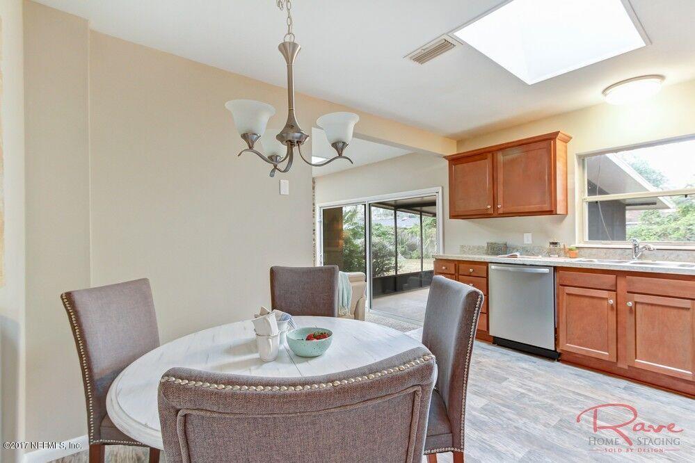 413 Baisden Road Jacksonville, FL 32218 - Photo 18 of 31 a dining room with furniture a chandelier and window