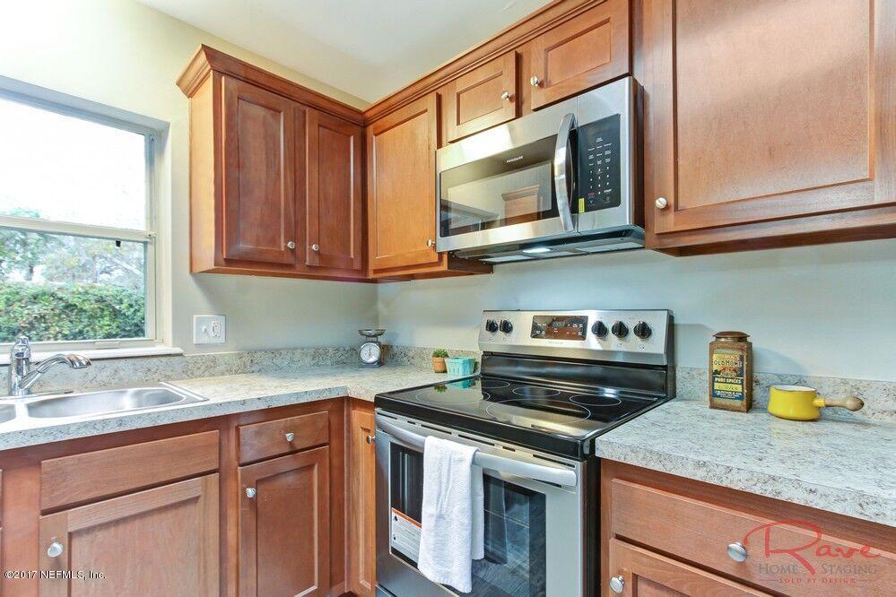 413 Baisden Road Jacksonville, FL 32218 - Photo 19 of 31 a kitchen with stainless steel appliances granite countertop a sink and a microwave