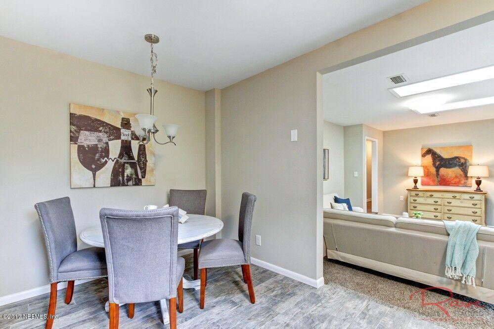413 Baisden Road Jacksonville, FL 32218 - Photo 20 of 31 a view of a dining room with furniture and wooden floor
