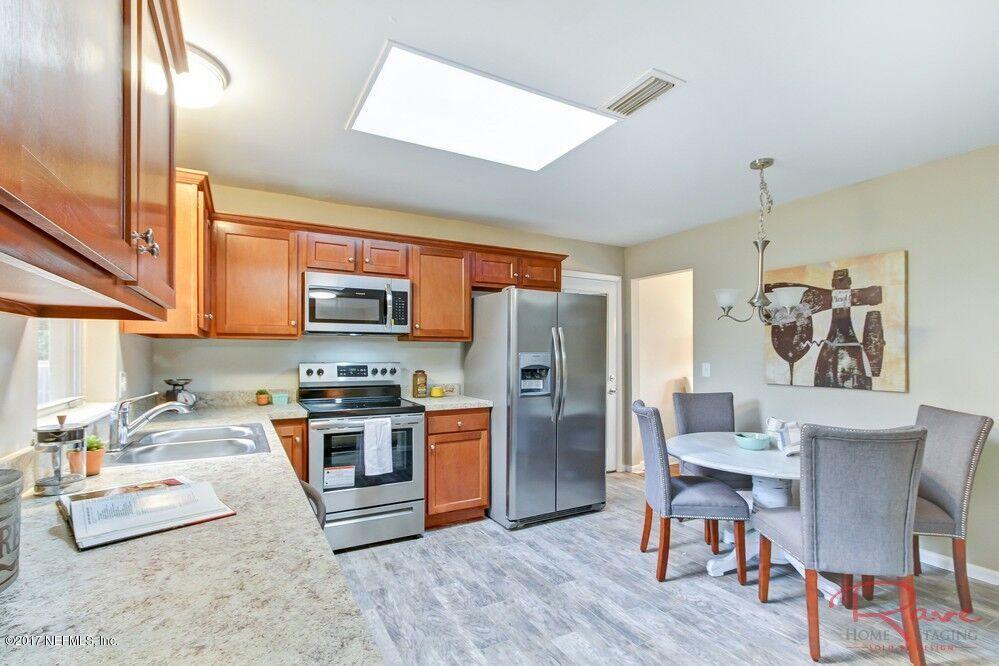 413 Baisden Road Jacksonville, FL 32218 - Photo 23 of 31 a kitchen with stainless steel appliances granite countertop a refrigerator a oven a sink a stove and island with wooden floor