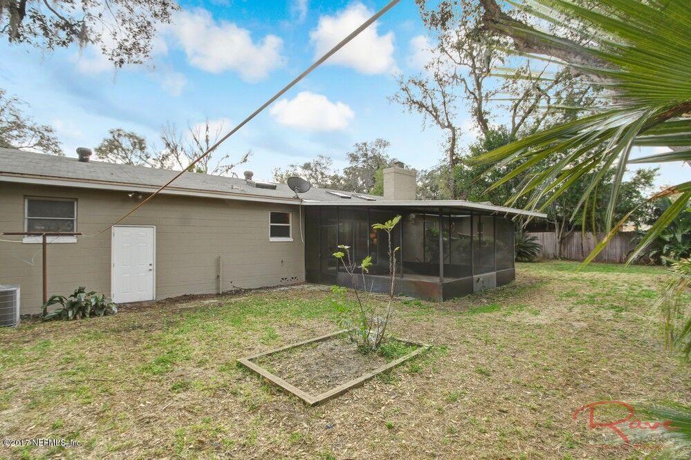 413 Baisden Road Jacksonville, FL 32218 - Photo 30 of 31 a backyard of a house with lots of green space