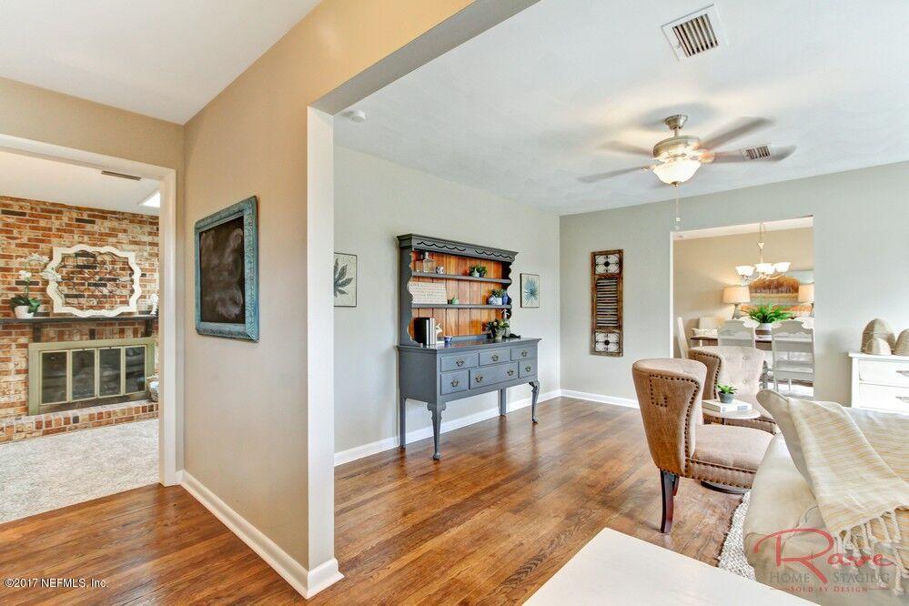 413 Baisden Road Jacksonville, FL 32218 - Photo 6 of 31 a view of a livingroom with furniture a ceiling fan and wooden floor