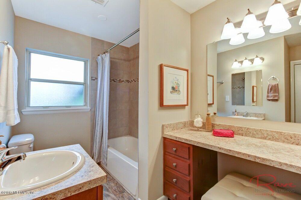 413 Baisden Road Jacksonville, FL 32218 - Photo 7 of 31 a bathroom with a tub sink and mirror