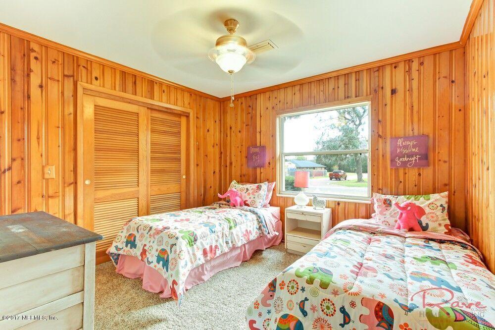 413 Baisden Road Jacksonville, FL 32218 - Photo 8 of 31 a bedroom with two beds and a chandelier