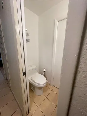 a view of an empty room with a bathroom