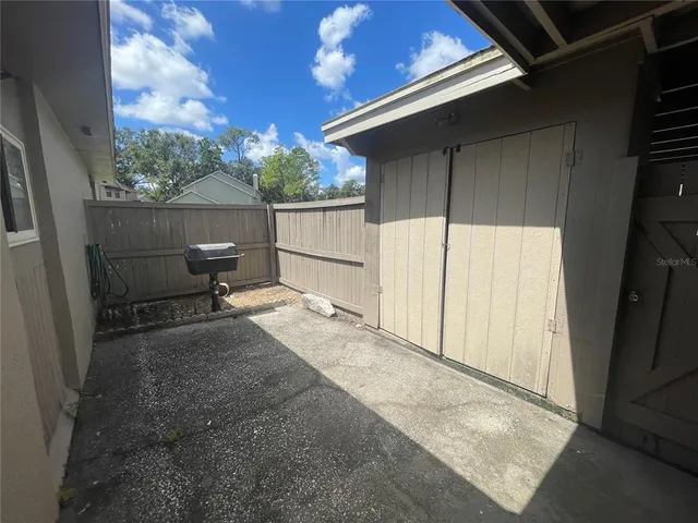 a backyard of a house with wooden fence