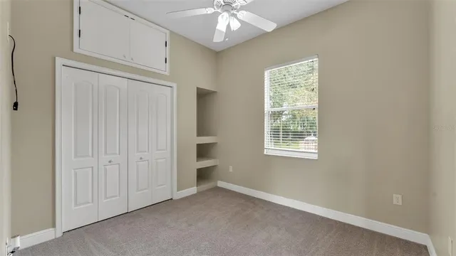 a utility room with granite countertop cabinets and sink