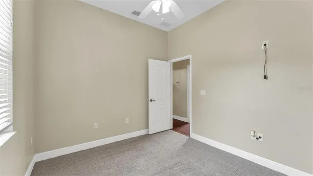 a bathroom with a granite countertop sink and white cabinets