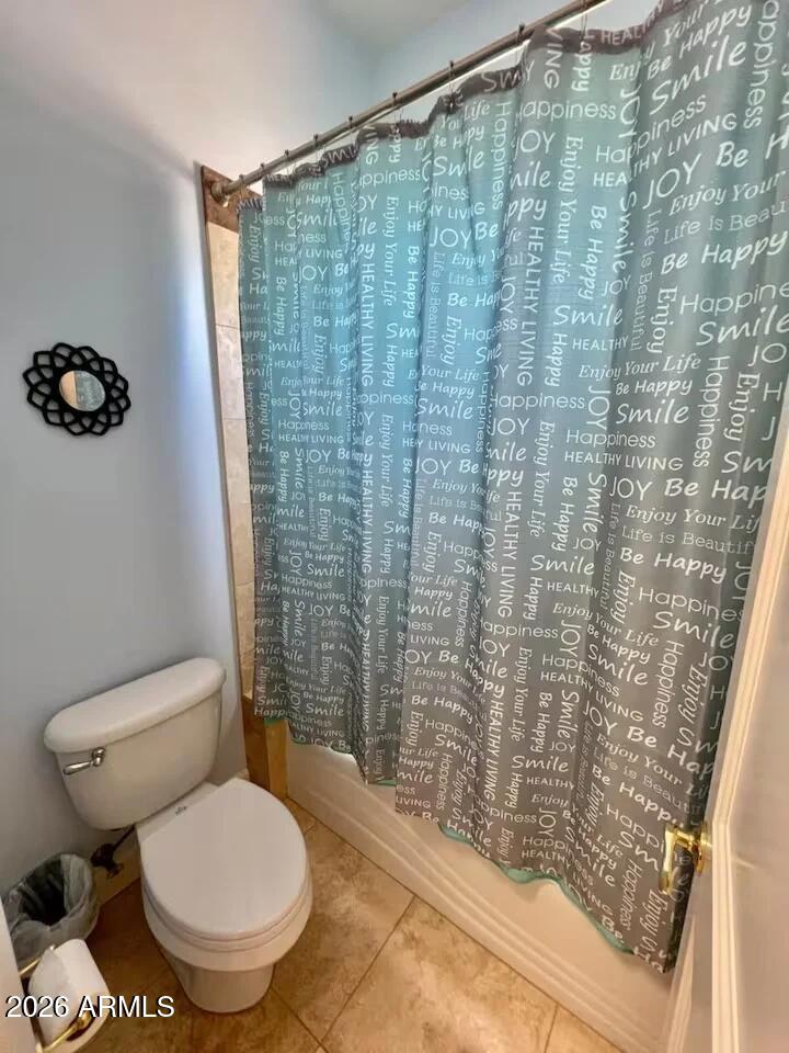 12198 East Doubletree Ranch Road Scottsdale, AZ 85259 - Photo 29 of 70 a bathroom with a toilet and a shower curtain