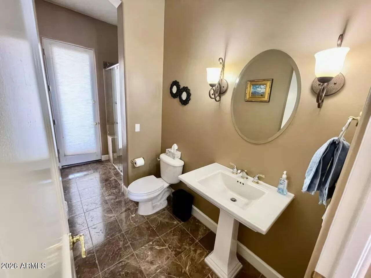 12198 East Doubletree Ranch Road Scottsdale, AZ 85259 - Photo 38 of 70 a bathroom with a toilet a sink and a mirror