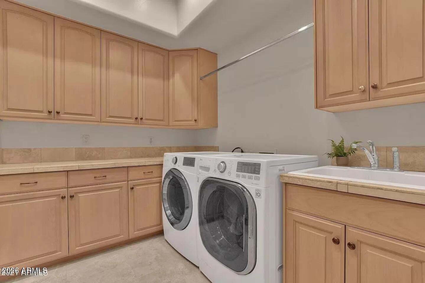 12198 East Doubletree Ranch Road Scottsdale, AZ 85259 - Photo 40 of 70 a utility room with sink dryer and washer