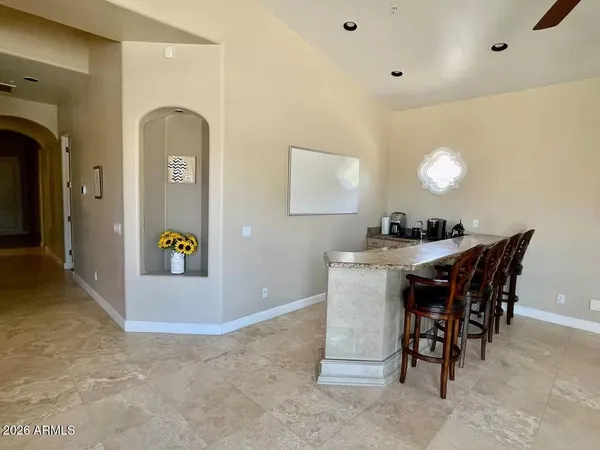 a view of a dining room with furniture and a chandelier