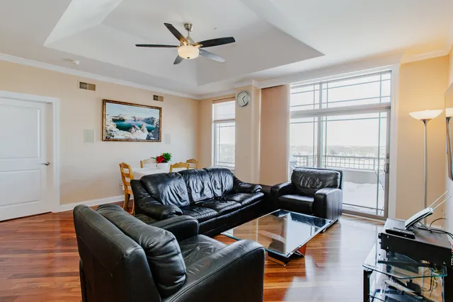 a living room with furniture ceiling fan and a window