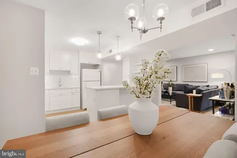 a view of living room filled with furniture and chandelier