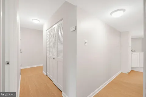 a view of a room with wooden floor and a bathroom