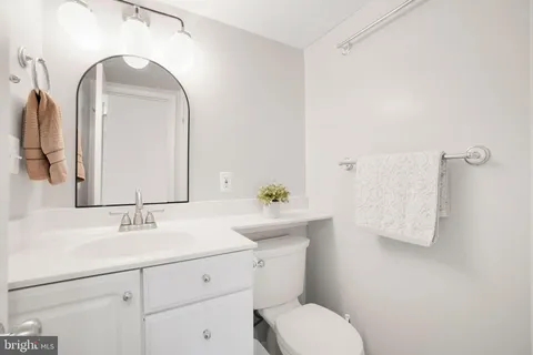 a bathroom with a sink toilet and mirror