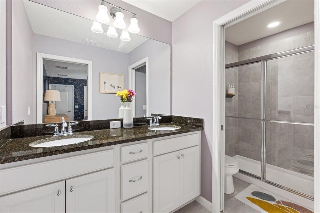 1864 Nice Court Kissimmee, FL 34747 - Photo 17 of 35 a bathroom with double sink and a mirror