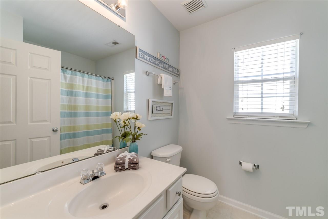 8404 Whisper Ridge Place Raleigh, NC 27613 - Photo 16 of 25 a bathroom with a sink toilet and shower