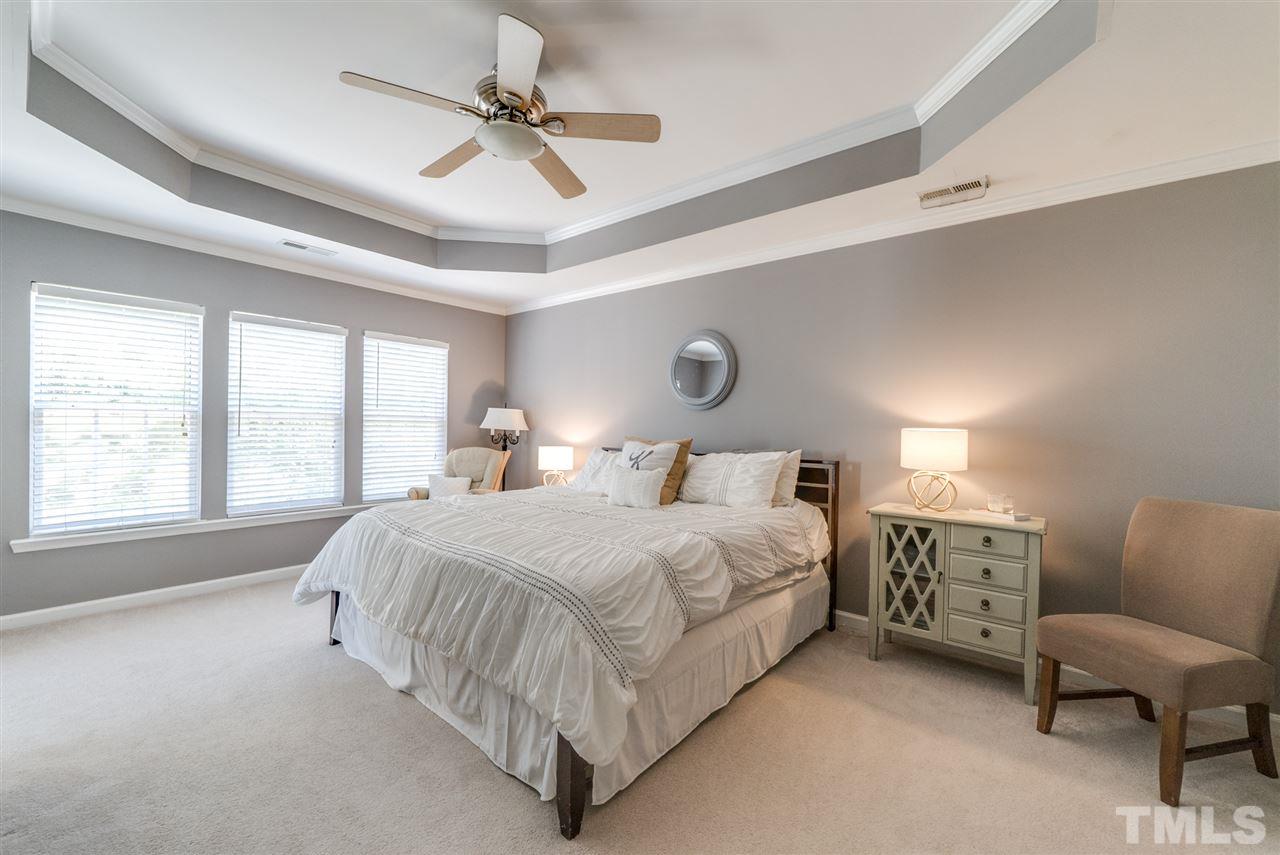 8404 Whisper Ridge Place Raleigh, NC 27613 - Photo 18 of 25 a bedroom with a bed couch and window