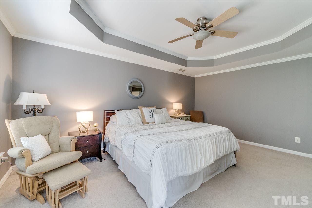 8404 Whisper Ridge Place Raleigh, NC 27613 - Photo 19 of 25 a bedroom with a bed and a couch