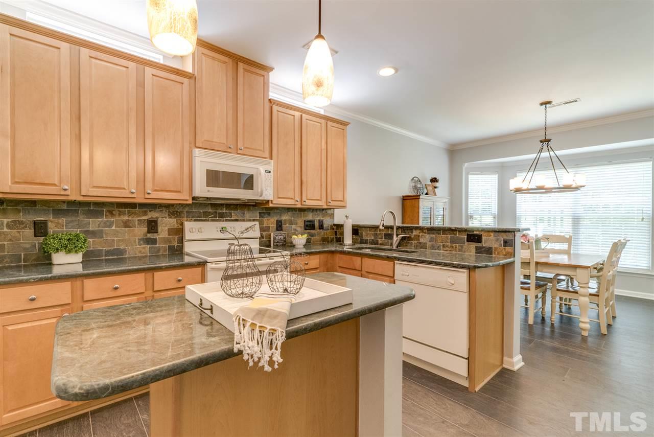 8404 Whisper Ridge Place Raleigh, NC 27613 - Photo 4 of 25 a kitchen with a sink a counter top space and appliances